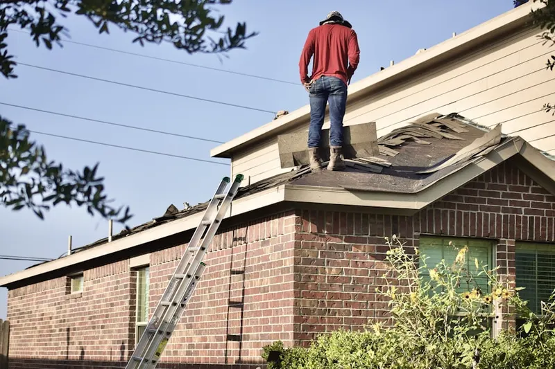 Professional roofer working on a residential roof in Leland